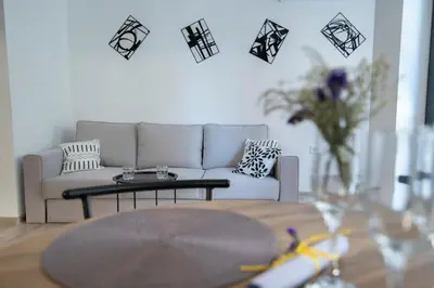 a living room with a couch and a table at Apartment By The River 5 in Plovdiv