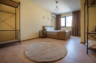 a bedroom with a bed and a large rug at Apartment By The River 5 in Plovdiv