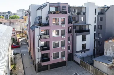 an apartment building with a pink exterior at Apartment By The River 5 in Plovdiv
