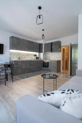 a living room with a couch and a table at Apartment By The River 5 in Plovdiv