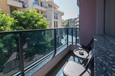 a balcony with a table and a chair on it at Apartment By The River 5 in Plovdiv