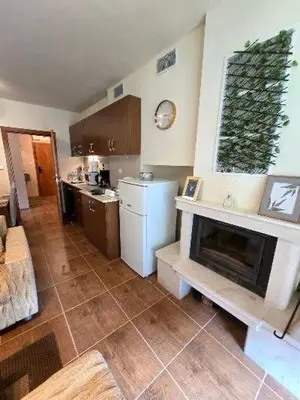 a kitchen with a fireplace in the middle of a room at Lucky SP apartments -Pamporovo in Bŭnzareto