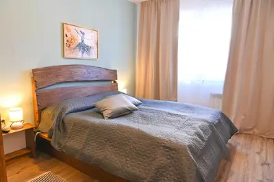 a bedroom with a bed and a window at Comfortable 2-Bedroom Apartment Near the Ski Lift by Flat Mаnаger in Bansko