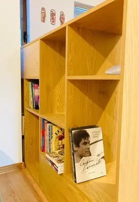 a book shelf with a book on it at Spacious & Classy 2BDR Apartment with 2 Baths in Plovdiv Centre in Plovdiv