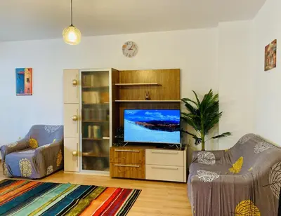 a living room with a television and two chairs at Spacious & Classy 2BDR Apartment with 2 Baths in Plovdiv Centre in Plovdiv