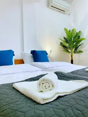 two beds with a towel on top of them at Spacious & Classy 2BDR Apartment with 2 Baths in Plovdiv Centre in Plovdiv