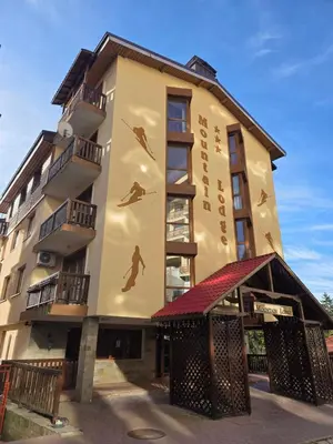 a building with a painting of a man on it at TMF Mountain Lodge Cozy Studio apartment in Pamporovo