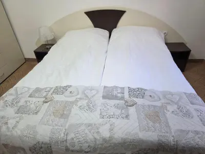 a bed with a quilt on it in a bedroom at TMF Mountain Lodge Cozy Studio apartment in Pamporovo