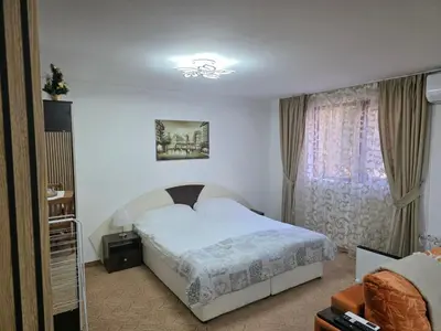 a bedroom with a white bed and a window at TMF Mountain Lodge Cozy Studio apartment in Pamporovo