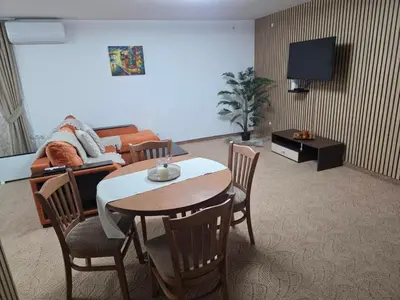 a living room with a table and a couch at TMF Mountain Lodge Cozy Studio apartment in Pamporovo