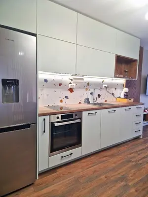 a kitchen with white cabinets and a counter top at By The Pool Apartments #7 in Velingrad