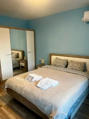 a bedroom with a bed with two towels on it at Raya - Apartmant in Plovdiv, with private parking in Plovdiv