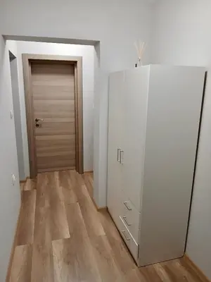 a hallway with a white cabinet and a door at Raya - Apartmant in Plovdiv, with private parking in Plovdiv