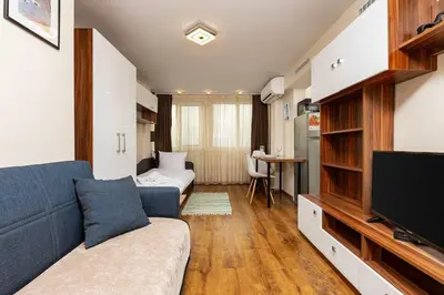 a living room with a couch and a tv at Convenient Studio with great view over Plovdiv in Plovdiv