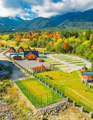 an aerial view of a farm with fall foliage at Camping Between the Mountains Bansko in Bansko
