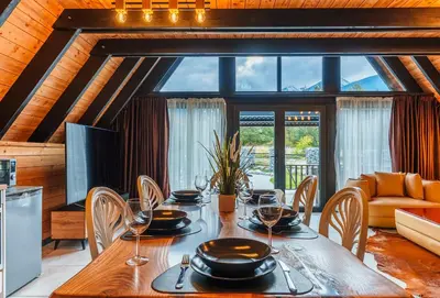 a dining room with a table with wine glasses at Camping Between the Mountains Bansko in Bansko