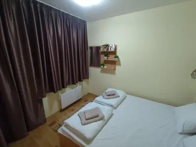a bedroom with a bed with two towels on it at Замъка in Pamporovo