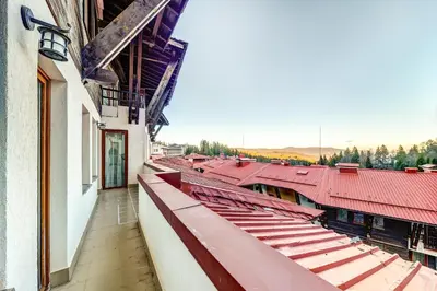 a view from the balcony of a building with red roofs at Two-bedroom Apartment in the Heart of the Rhodopes in Pamporovo