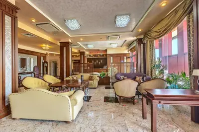 a lobby with couches and tables and chairs at Hotel Chiirite in Plovdiv