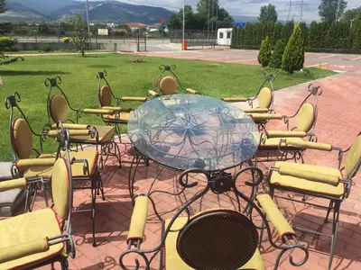 a group of chairs sitting around a glass table at Hotel Chiirite in Plovdiv