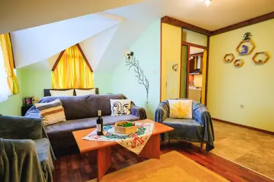 a living room with a couch and a table at Fantasy in Bansko