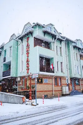 a large building on a street in the snow at Fantasy in Bansko