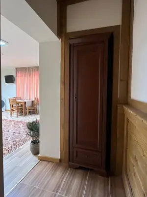 a wooden door in a room with a living room at PIRIN GOLF DELUXE PRIVATE STUDIO GABBY ground floor in Bansko