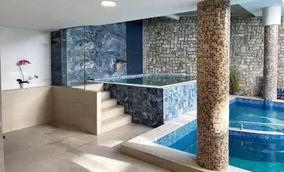 a swimming pool in a house with a tub at Studio 4, 4min walk to slope at Predela2 Bansko in Bansko
