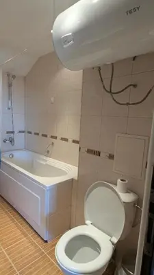 a bathroom with a toilet and a bath tub at Mountain view apartment at Emerald Hotel in Bansko