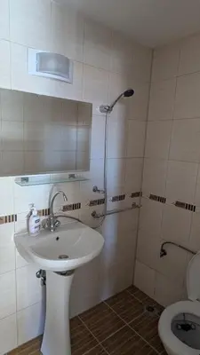 a bathroom with a sink and a shower and a toilet at Mountain view apartment at Emerald Hotel in Bansko