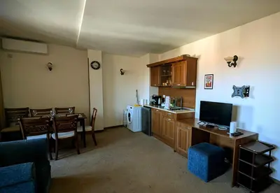 a living room with a kitchen and a dining room at Mountain view apartment at Emerald Hotel in Bansko