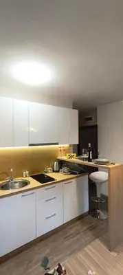 a kitchen with white cabinets and a sink at VB Residence Vitosha View Apartment in Sofia