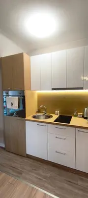 a kitchen with white cabinets and a sink at VB Residence Vitosha View Apartment in Sofia