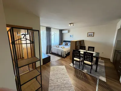 a room with a bed and a bedroom with a table at Bansko Royal Towers Ski Lift View in Bansko