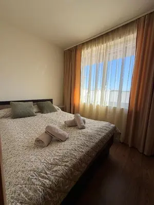 a bedroom with a bed with two towels on it at Bansko Royal Towers Ski Lift View in Bansko
