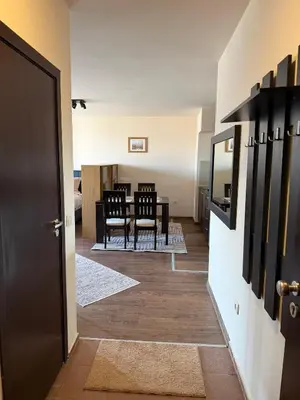 a dining room and kitchen with a table and chairs at Bansko Royal Towers Ski Lift View in Bansko