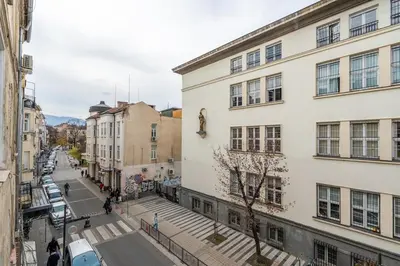 an empty street in a city with buildings at The Urban Pulse Stylish Flat in Sofia