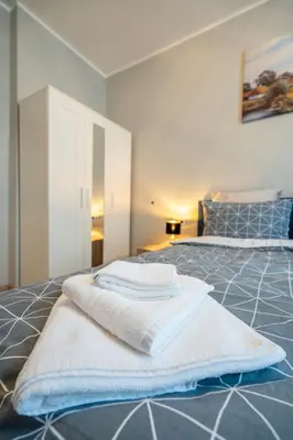 a bedroom with two beds with towels on them at The Urban Pulse Stylish Flat in Sofia