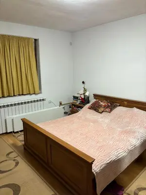 a bedroom with a bed and a window at Kiryanov's apartment in Sandanski