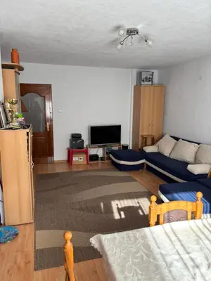 a living room with a couch and a tv at Kiryanov's apartment in Sandanski