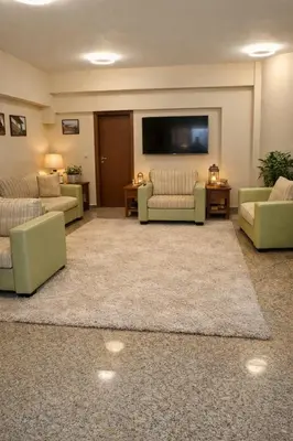 a large living room with couches and a flat screen tv at Хотел Ривърсайд Анекс in Bansko