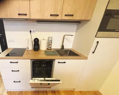 a small kitchen with a sink and a microwave at Apartment Kapina in Pamporovo