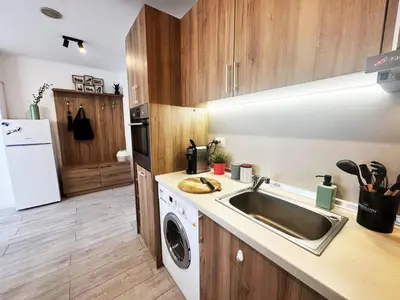 a kitchen with a sink and a washing machine at EMIS Alpine Retreat - Modern & Cozy & Bright in Bansko