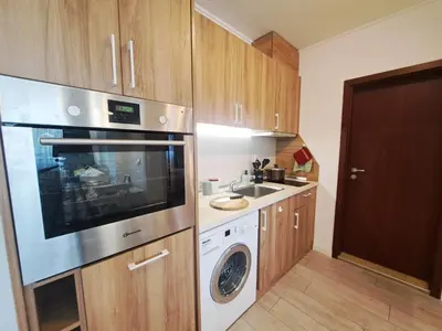 a kitchen with a washer and a sink and a microwave at EMIS Alpine Retreat - Modern & Cozy & Bright in Bansko