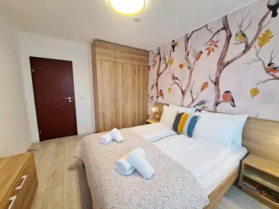a bedroom with a bed with towels on it at EMIS Alpine Retreat - Modern & Cozy & Bright in Bansko