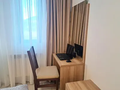 a room with a desk with a laptop and a chair at EMIS Alpine Retreat - Modern & Cozy & Bright in Bansko