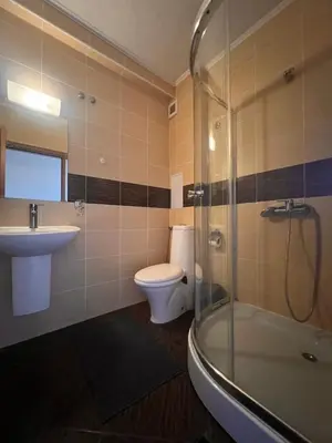 a bathroom with a toilet and a sink and a shower at Princeps De Cura Bansko in Bansko