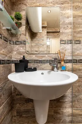 a bathroom with a white sink and a mirror at Square Slivnitsa 2BR apt 5 minutes from top center in Plovdiv