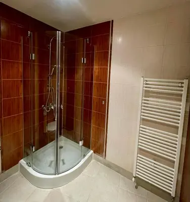 a shower with a glass door in a bathroom at ElGora Studio в Apart Hotel Comfort in Bansko