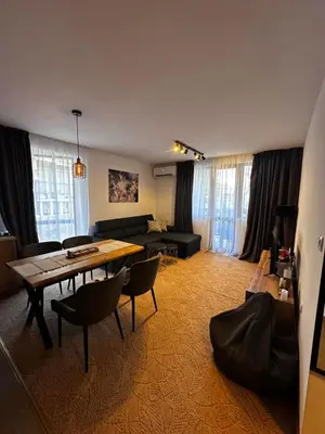 a living room with a table and a couch at Apartment 35 Mountain Lodge Pamporovo in Pamporovo